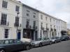 terrace of 9 houses built circa 1830-40 with later additions and alterations including shop fronts