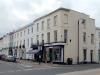 terrace of 9 houses built circa 1830-40 with later additions and alterations including shop fronts