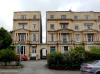 end of a terrace of 22 houses plus one joined by a mews arch at left, built circa 1832 by architects R W and C Jearrad