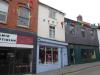 built in the late 16th or early 17th century; altered in the 18th and mid 19thy century; plastered timber-frame; front heightened and new shop front installed in the mid 19th century