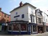 late 18th century front to 17th century core with later alterations including late 19th century shop front; rear 17th century timber-frame, restored in 1978