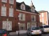 built circa 1750 with late additions and alterations including 1836-1899 dormers and shop front, gable end rebuilt circa 1950-70