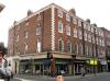 terrace of 4 houses built in the late 18th century with later additions and alterations including 1960s shop fronts