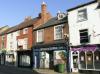 built in the early 19th century with later additions and alterations including late 19th century shop front