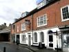 probably built circa 1801 for James Durnford, with earlier origins and later alterations and additions including 19th century shop fronts