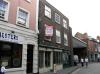 built in the early 18th century with later additions and alterations including mid 19th century shop front