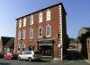 built in the mid 18th century, with later additions and alterations including late 19th century shop front