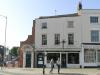 timber framed house built in the 16th/17th century with later additions and alterations including refacing and shop front in the mid 19th century