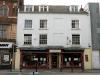 built circa 1736-99 with later additions and alterations including 1960's attic dormers and 1990's shop front