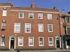 2 terraced houses built circa 1810-20 refronting earlier property with later additions and alterations