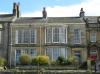 house built in the early-to-mid19th century with addtions at the left made in the 1930s